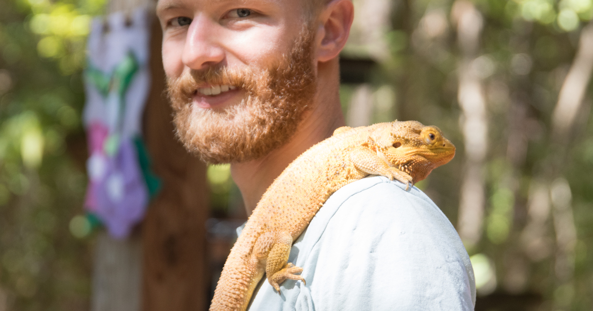 man with lizard on his shoulder