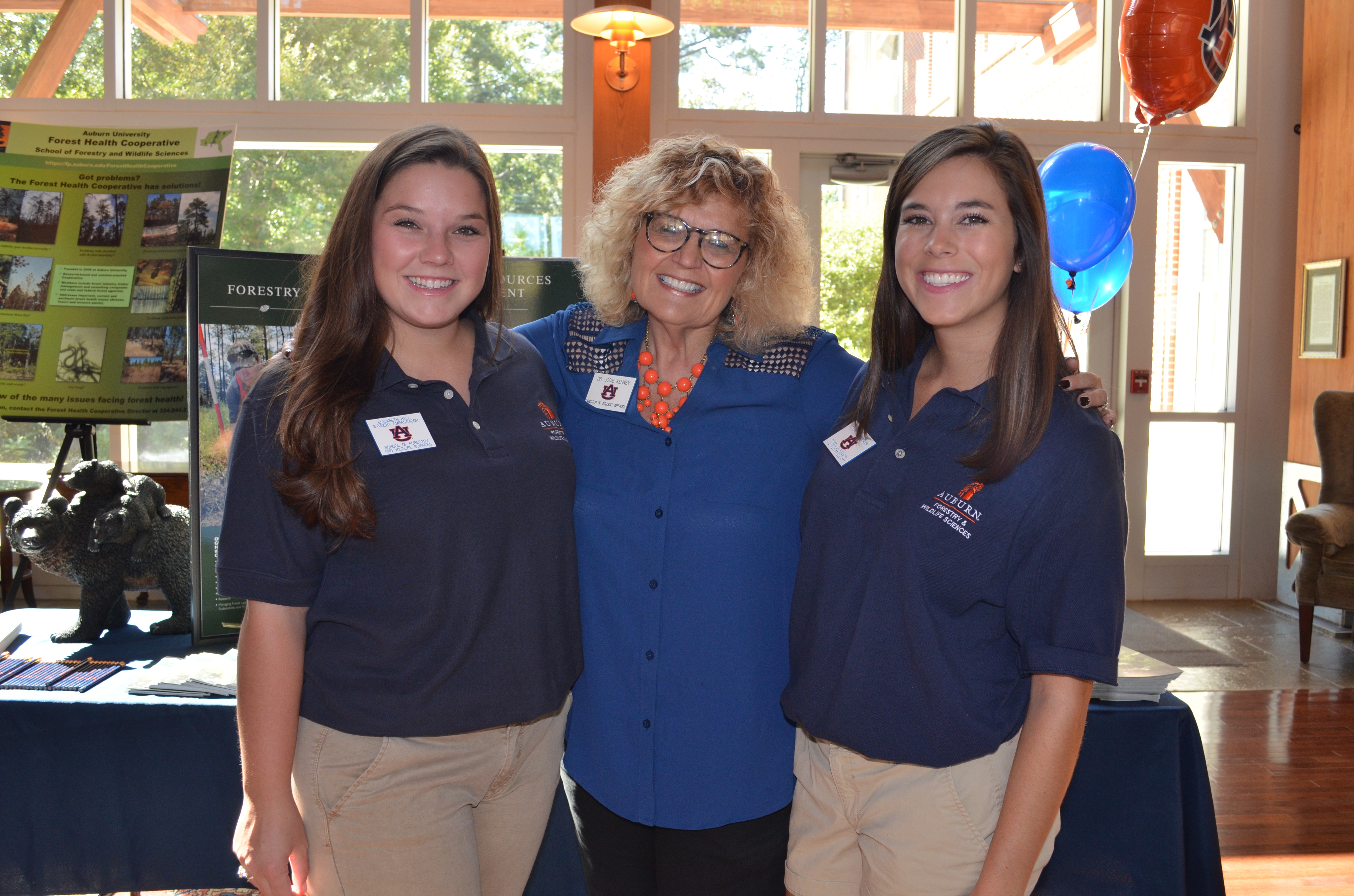 students with staff member at family open house