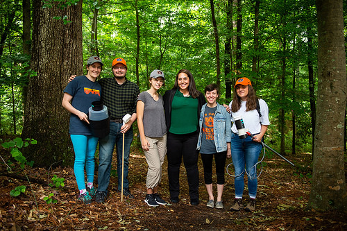 the entire research team poses for photo in woods