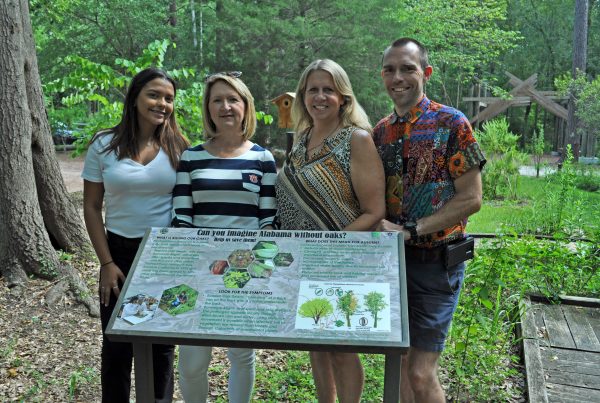 As part of Diana P. Zurillo Riveria’s Research Experiences for Undergraduates, or REU, at Auburn University, Zurrillo produced educational signage for the Kreher Preserve and Nature Center, or KPNC, regarding sudden oak death. Shown from left to right are Zurrillo, Professor Lori Eckhardt and KPNC staff, Jennifer Lolley and Michael Buckman.