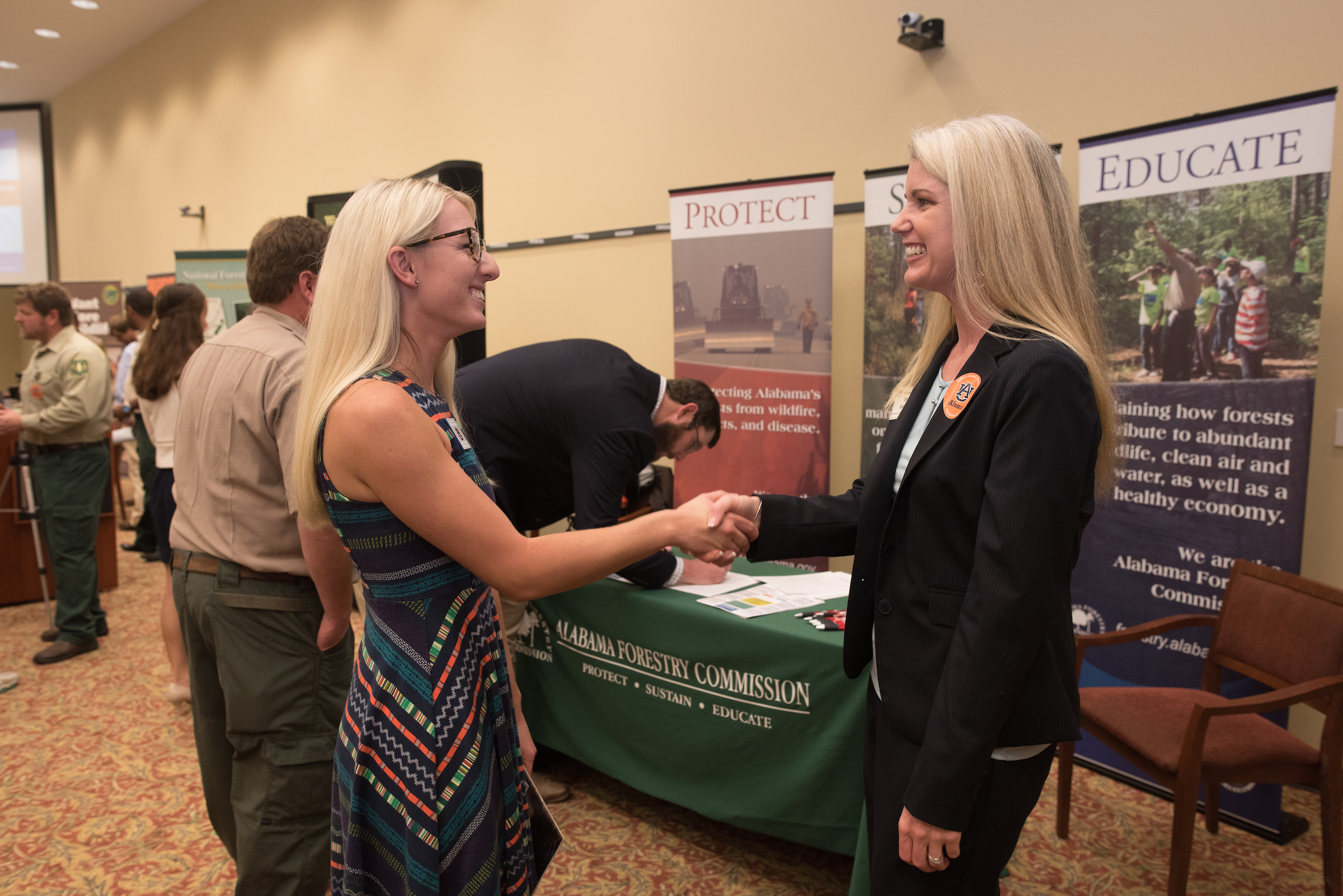 student shakes hand of employer