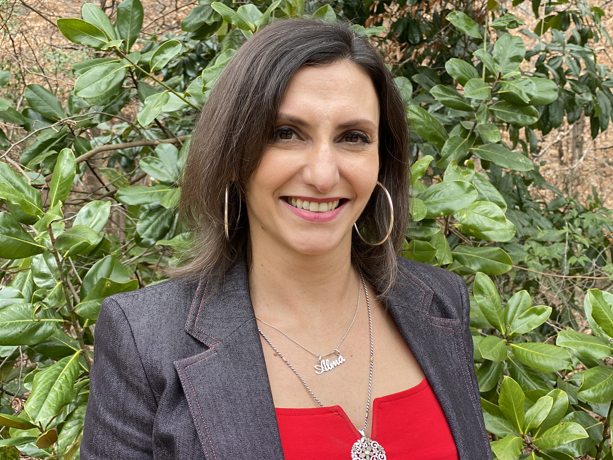 Maria Soledad Peresin headshot in front of greenery