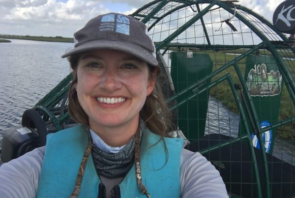 Dunning smiling on an airboat on the water.