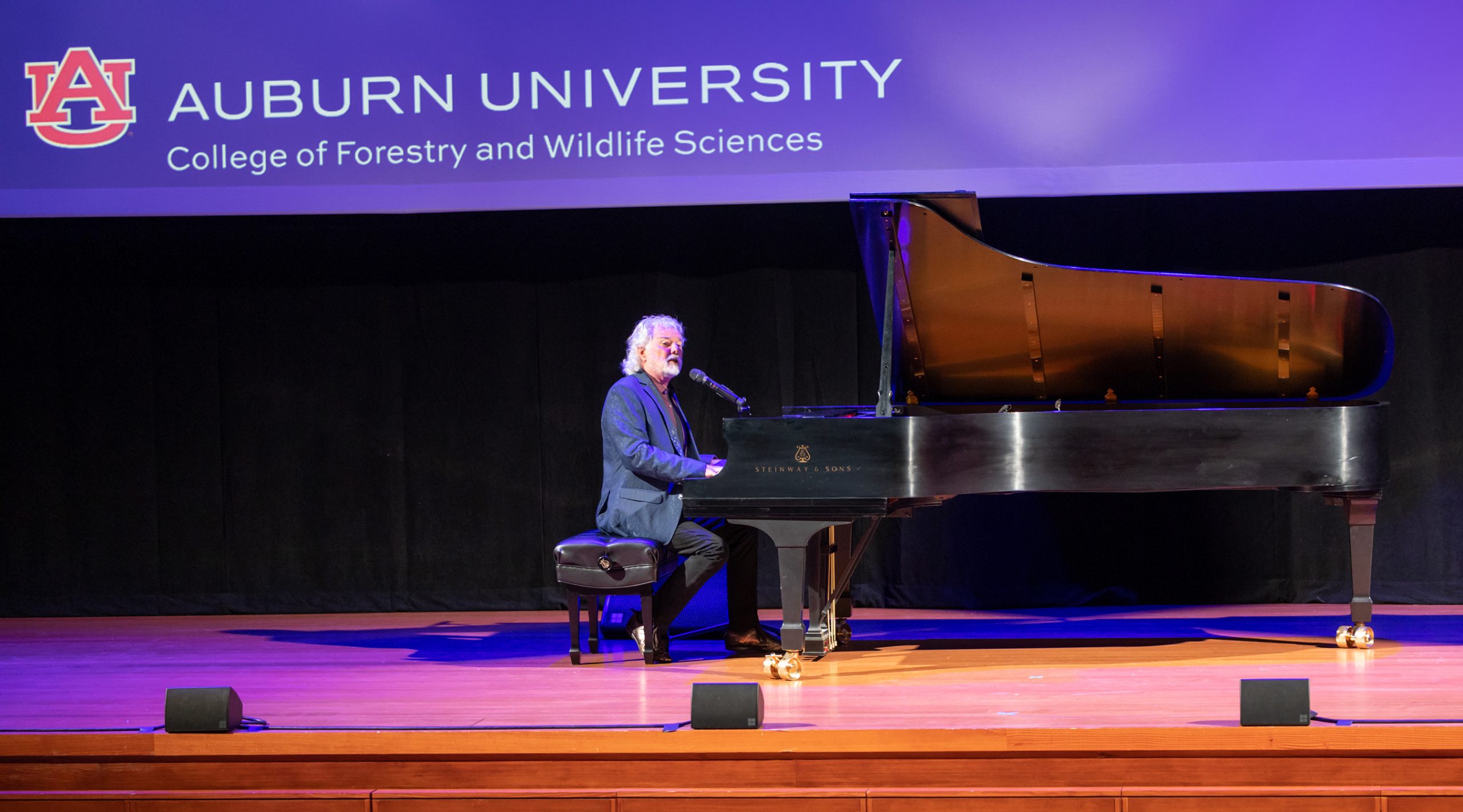 Broad shot of Leavell playing the piano.