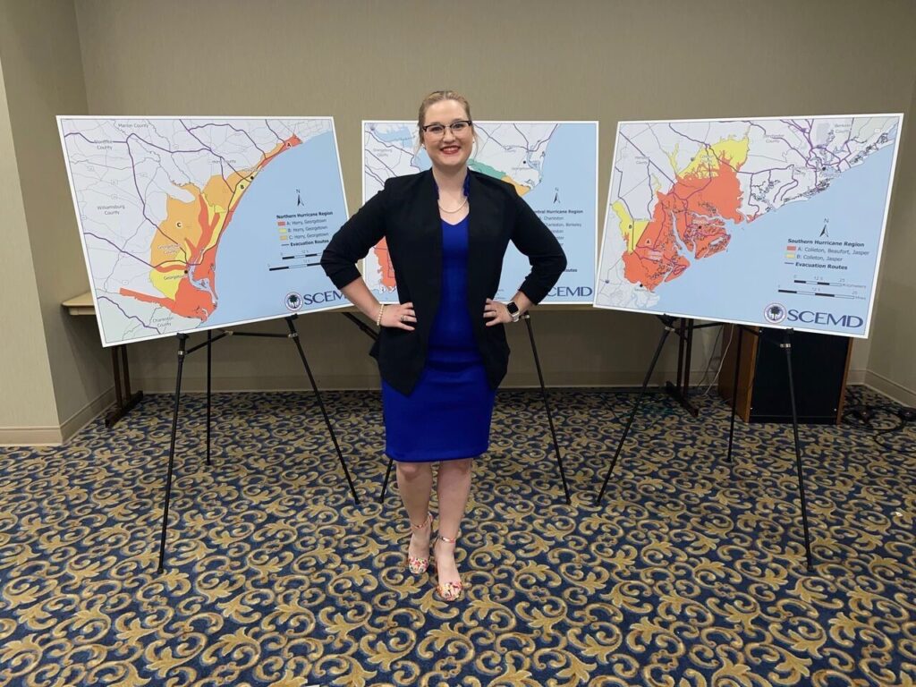 Emily Razzano at the 2022 Governor’s Hurricane Tabletop Exercise with the poster from her team at the South Carolina Emergency Management Division. 