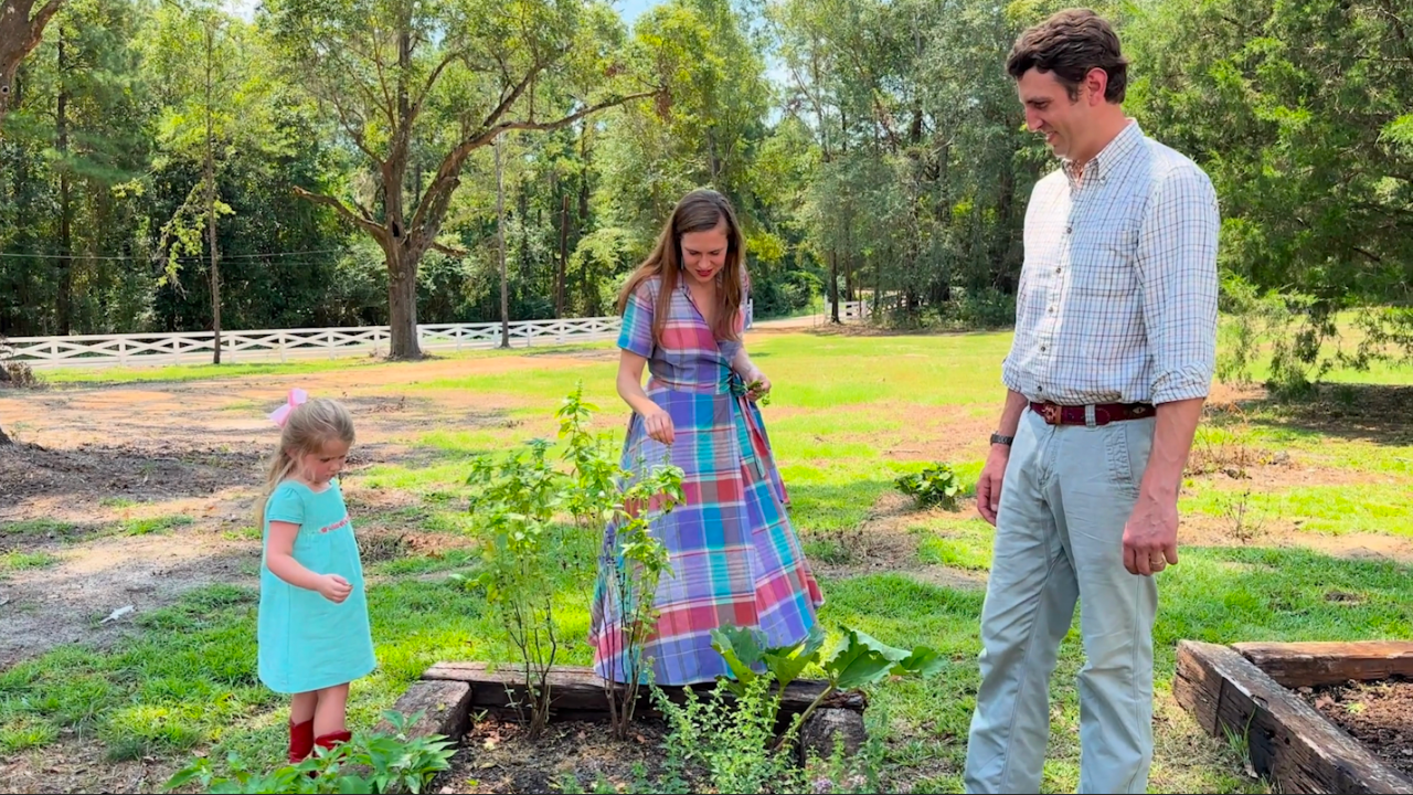 Bobby Dobson tending to a garden with family