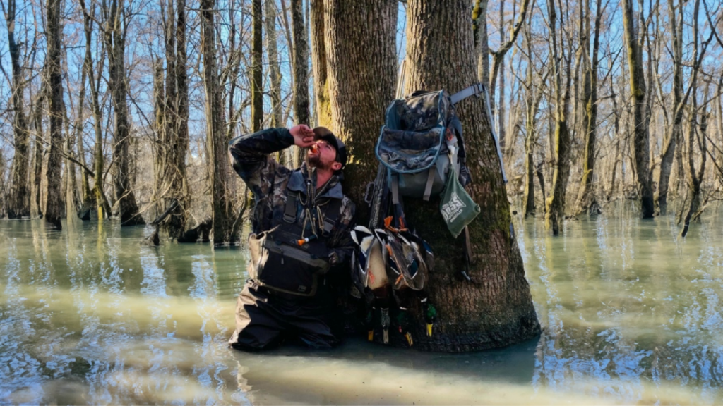 Travis Black using a duck call whistle during a waterfowl hunt