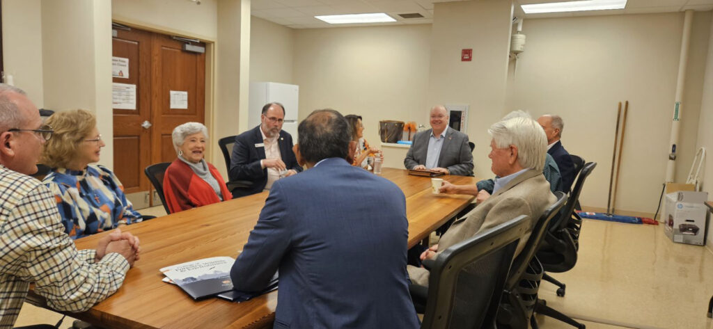 President Chris Roberts talks with Dixon Foundation board members
