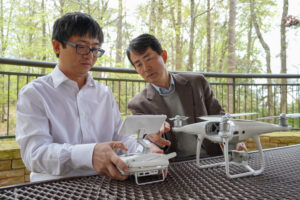 Zutao Yang and Li An working together on a drone.