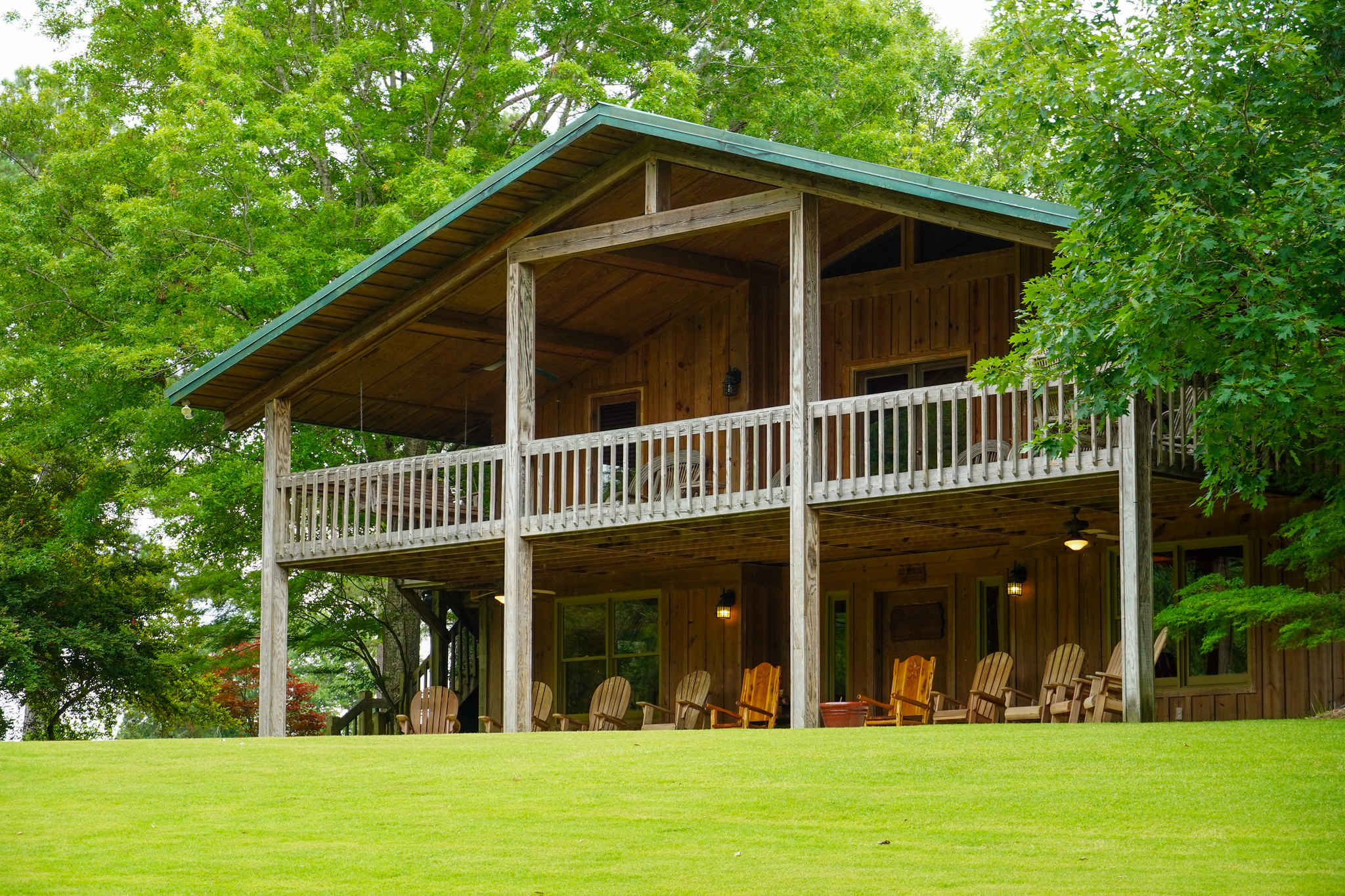 Two story cabin in greenery