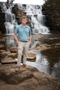 Matthew Capps standing at the Chewacla State Park's waterfall. 