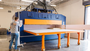 a student operates a mass timber press.