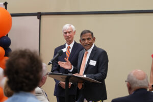 CFWE Dean Janaki Alavalapati presents Joe Twardy with his award at a podium.