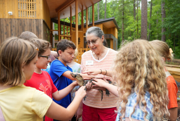 Emily Kling holds an alligator for example to Summer Ecology camp students.