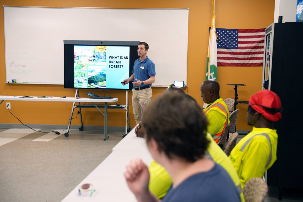 Georgios Arseniou leads discussion about urban forests, participants look on