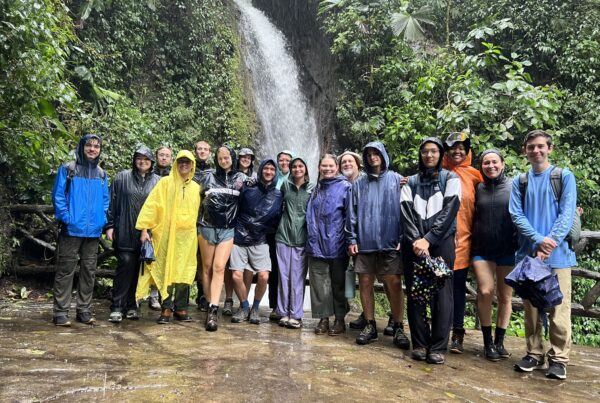 Group photo in front of waterfall.