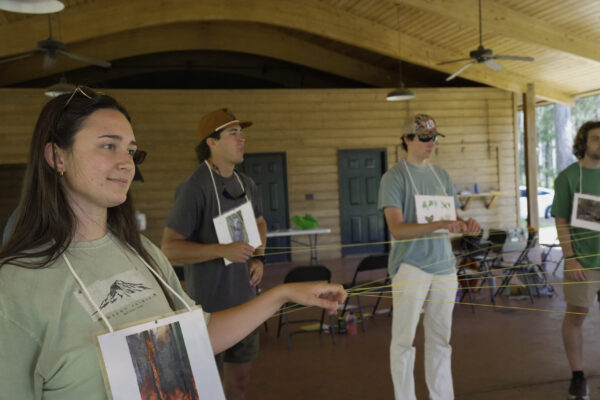 Students gathered around to practice hands-on learning activities.