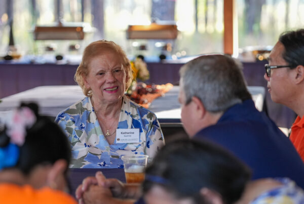 Woman sitting at table smiling