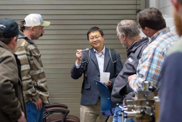 Yucheng Peng holds up a bio-based product during a stakeholder research tour.