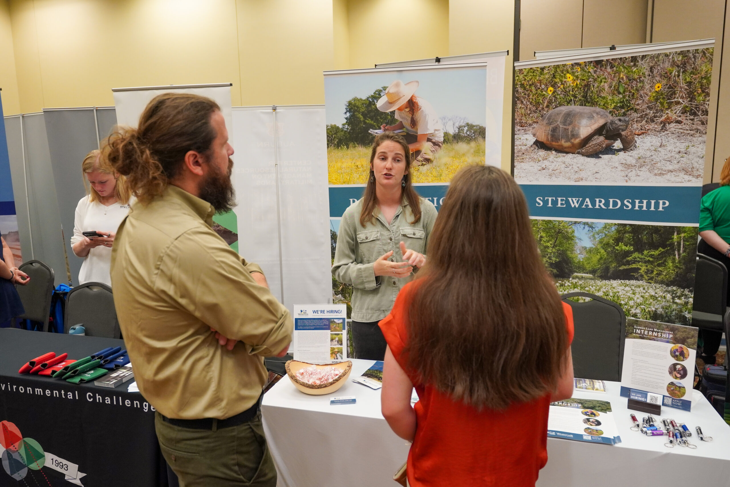 two people speak to an employer about wildlife conservation