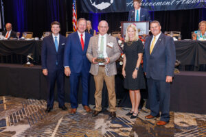 Joel Martin standing with award presenters at AWF award ceremony 