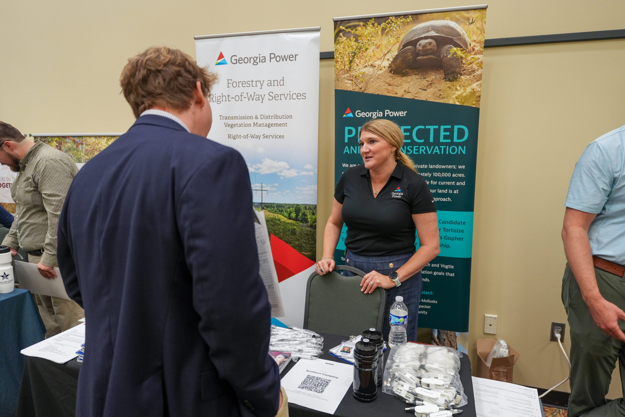 male student speaks to potential female employer at career fair