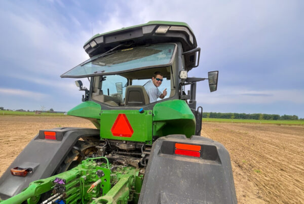Harris Crumpton on tractor in crop field