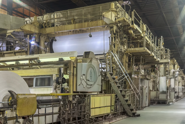 A large roll of containerboard moves through the production line at a South Alabama mill